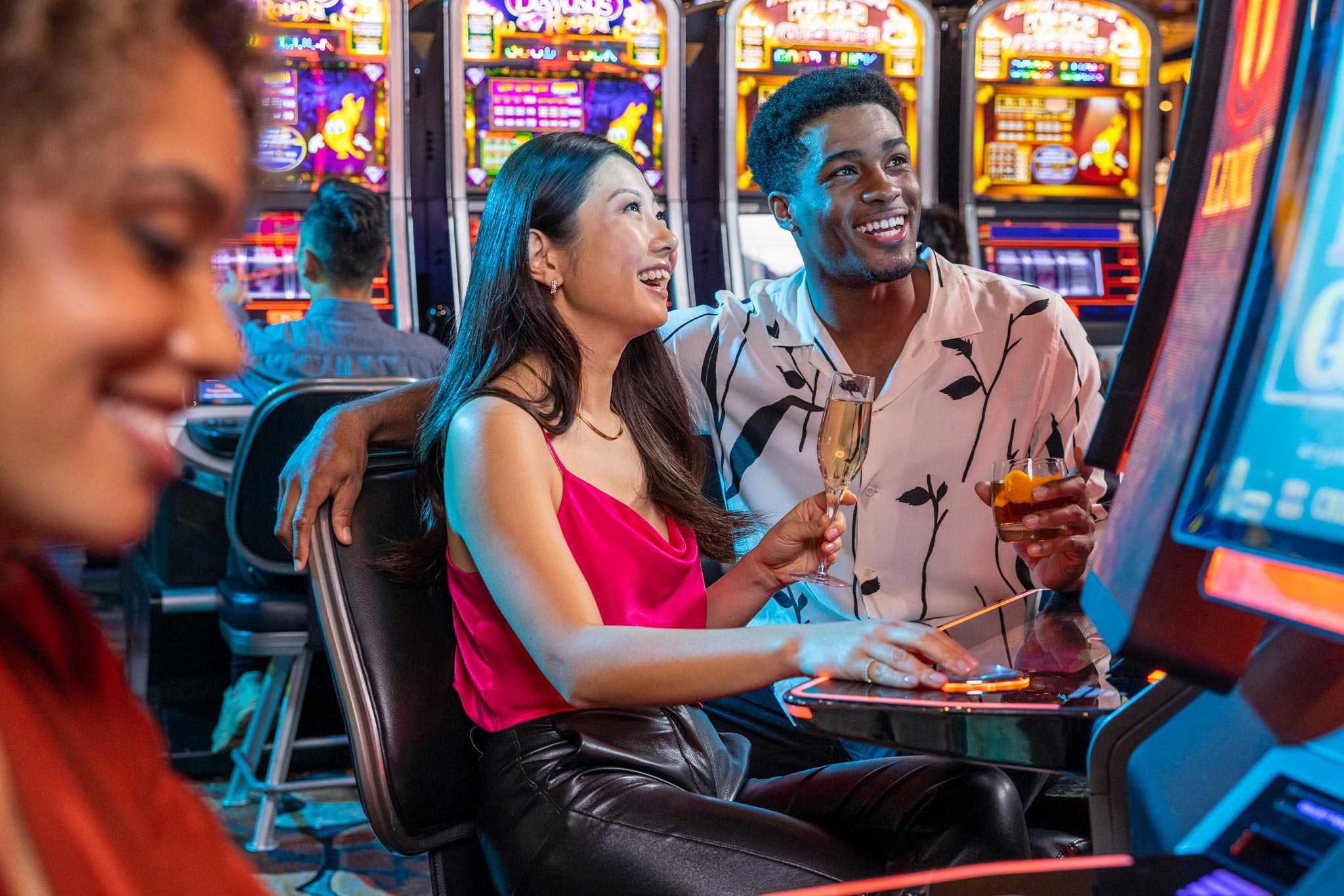 A couple having a good time playing slot machines in San Diego's Jamul Casino Resort.